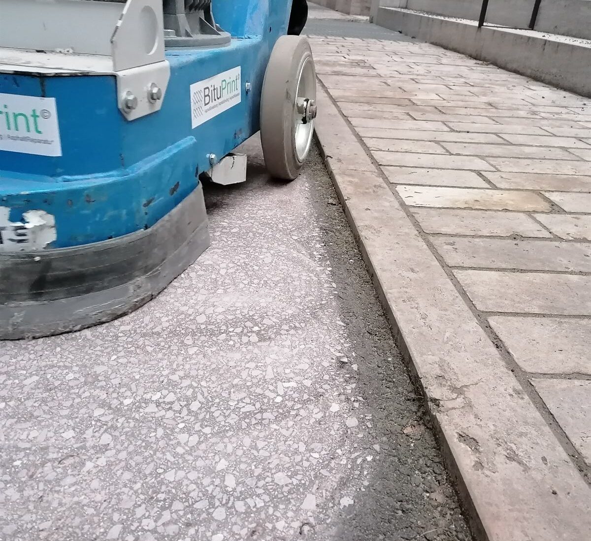Randbearbeitung beim Asphalt Grinding – Maschinelle Bearbeitung bis dicht an den Bordstein